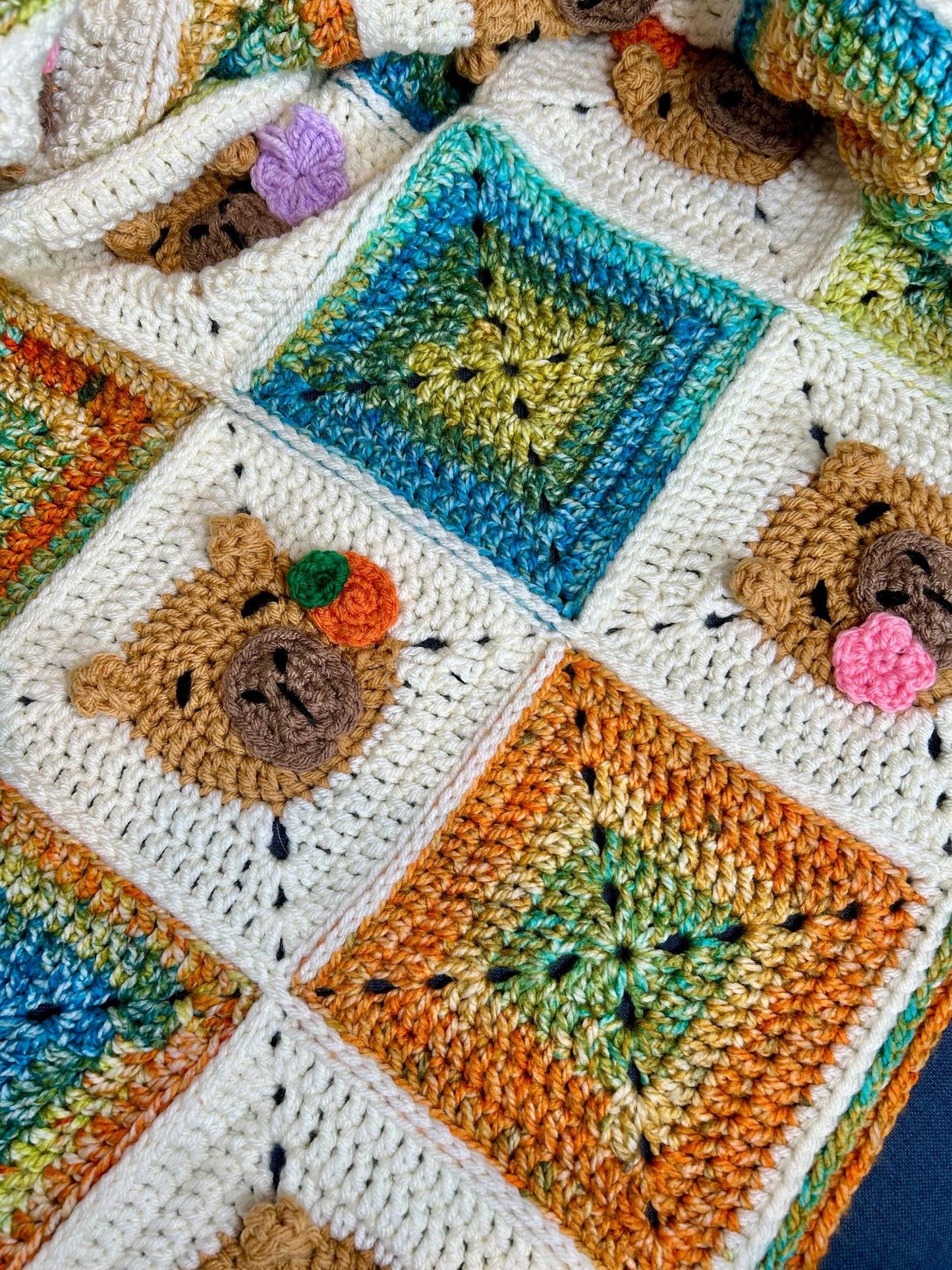 Capybara crochet blanket pattern. PDF download, UK and US terms. Bright colors.